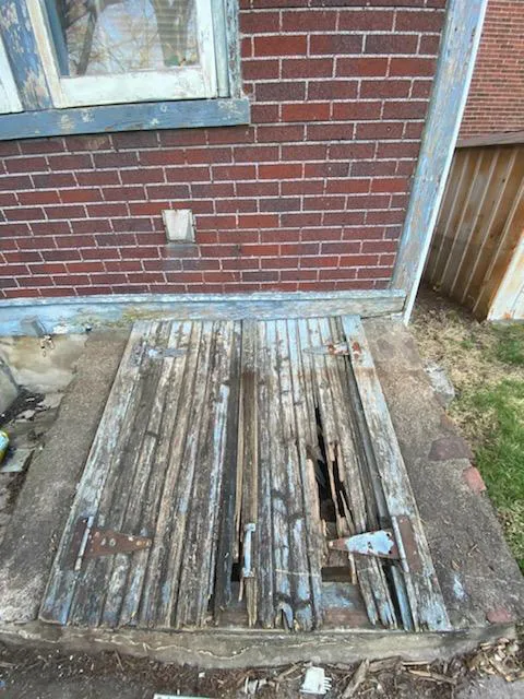a rotted cellar door that probably couldn't support the weight of a toddler