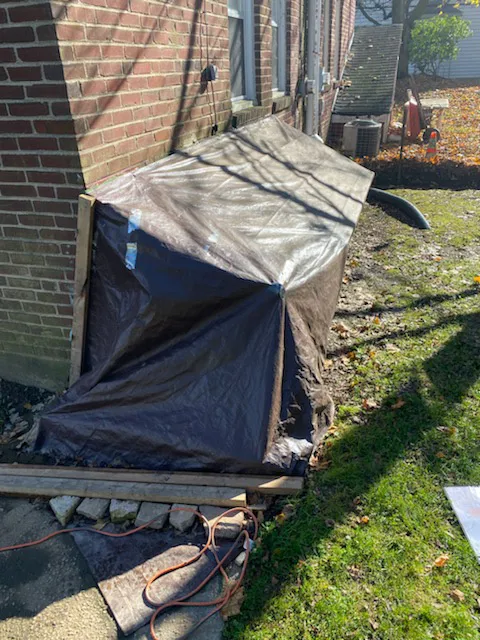 tarp covering cellar door entrance
